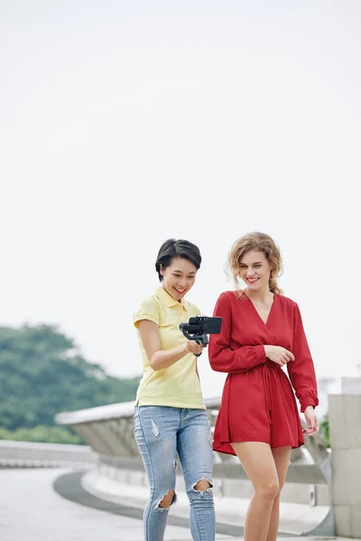 Smiling Young Multi Ethnic Women Walking Outdoors Watching Video Filmed — 스톡 사진