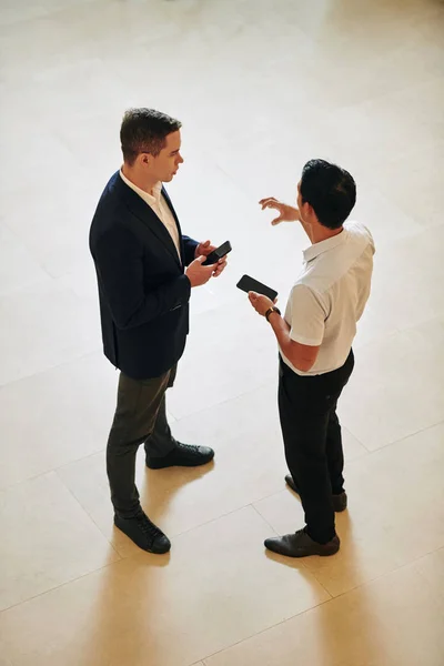 Mitarbeiter Mit Smartphones Der Hand Stehen Der Halle Des Bürogebäudes — Stockfoto