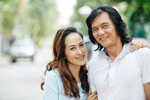 Portrait Cheerful Mature Vietnamese Couple Hugging Looking Camera Standing Outdoors — Stock Photo, Image
