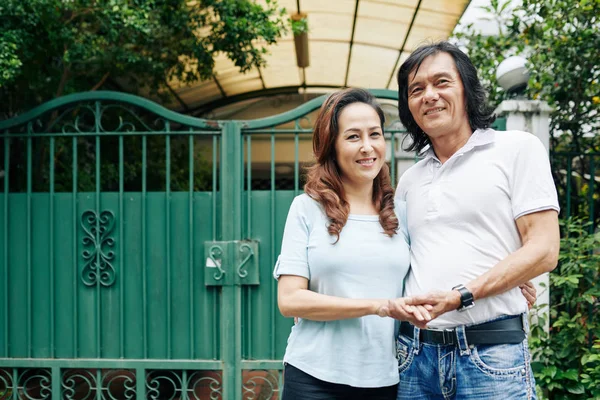 Portrait Happy Mature House Owners Standing Gates Holding Hands Looking — Stock Photo, Image