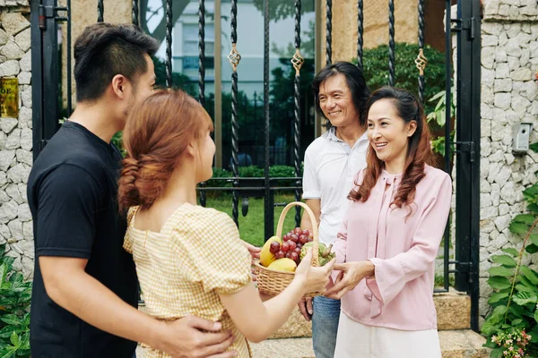 Happy Mature Asian Couple Greeting Adult Son His Girlfriend Entrance — Stock Photo, Image