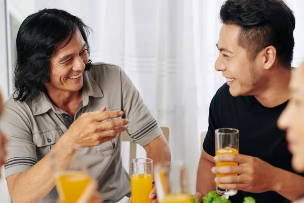 Mature Asian Man His Adult Son Drinking Juice Joking Family — Stock Photo, Image