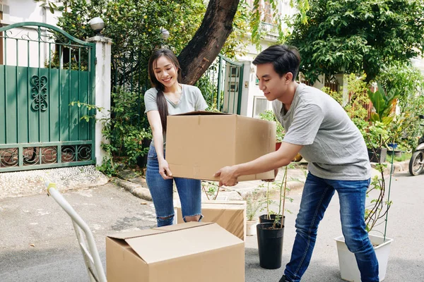 Cheerful Young Vietnamese Couple Moving Out Carrying Cardboard Boxes Outdoors — ストック写真