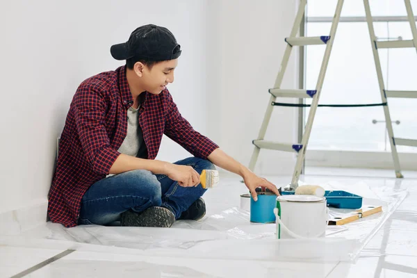 Smiling Young Asian Man Cap Plaid Shirt Opening Can Paints — Stok Foto