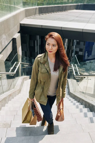 Smiling Young Vietnamese Woman Carrying Paper Bags Walking Stairs Undergroung — 스톡 사진