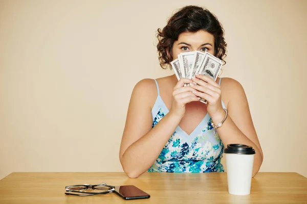 Portrait Pretty Young Woman Sitting Table Covering Mouth Banknotes Looking — Stock Photo, Image