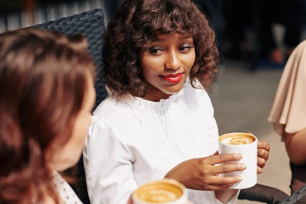 Beautiful Young Black Woman Drinking Big Mug Cappuccino Listening Story — Stock Photo, Image