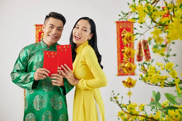 Joyful Young Couple Showing Red Envelopes Gifting Family Members Friends — 스톡 사진