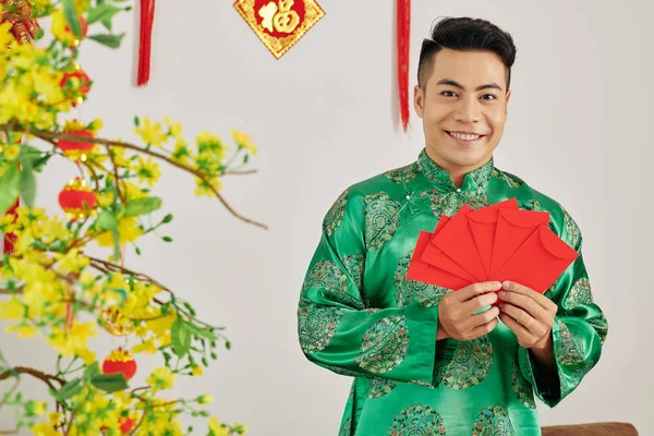 Positive Young Asian Man Traditional Costume Holding Red Lucky Money — 스톡 사진