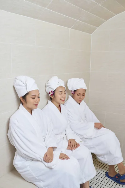 Three Asian Women Wearing White Robes Towel Turbans Sitting Together — Stock Photo, Image