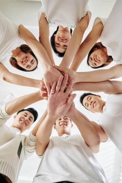 Happy Excited Young Volunteers Stacking Hands Express Unity Looking Camera — Stock Photo, Image