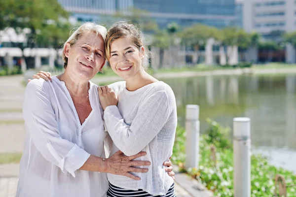 Cheerful Middle Aged Woman Hugging Her Adult Daughter Looking Camera — Stock Photo, Image