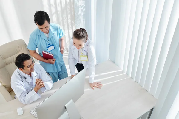 Grupo Médicos Reunidos Computadora Para Discutir Nuevo Programa Para Servicio —  Fotos de Stock