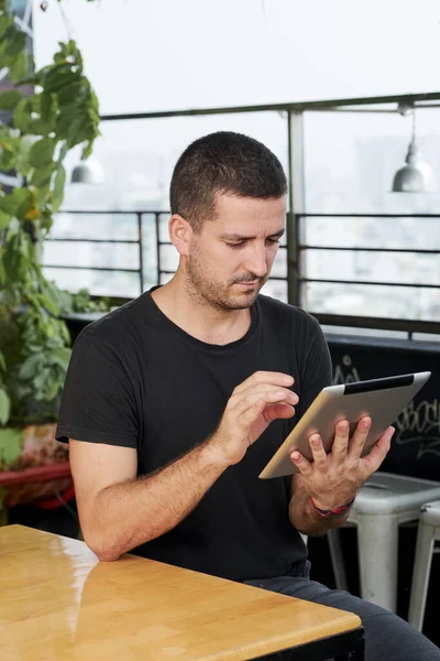 Pensive Frowning Young Man Reading Article Mail Tablet Computer Sitting — Foto de Stock