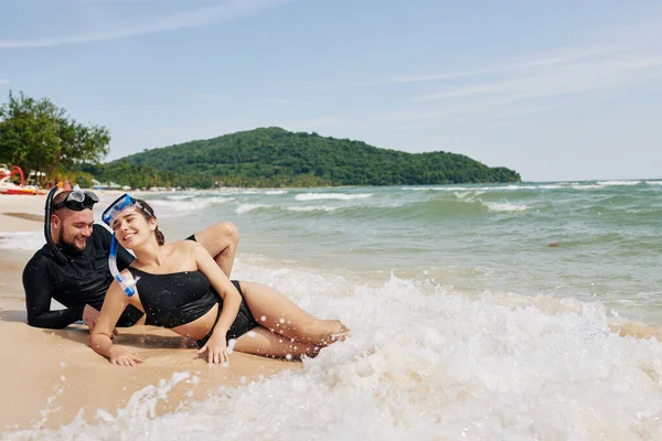 Feliz Pareja Joven Acostada Playa Disfrutando Las Cálidas Olas Mar —  Fotos de Stock