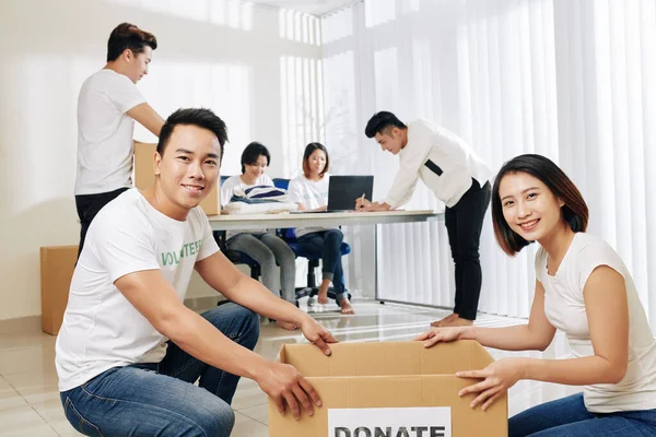 Workflow Donation Center Young Couple Packing Donated Clothes Colleagues Working — Stock Photo, Image