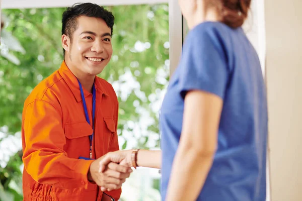 Smiling Handsome Asian Service Worker Shaking Hand Female Customer Opening — Stock Photo, Image