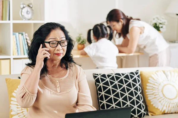 Senior Vietnamesiska Kvinna Glasögon Talar Telefon När Läser Affärsdokument Bärbar — Stockfoto