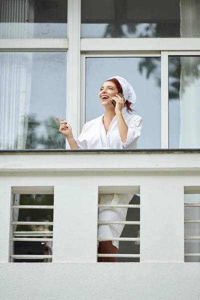 Excited Laughing Young Woman Bathrobe Standing Balcony Talking Phone Best — Stock Photo, Image