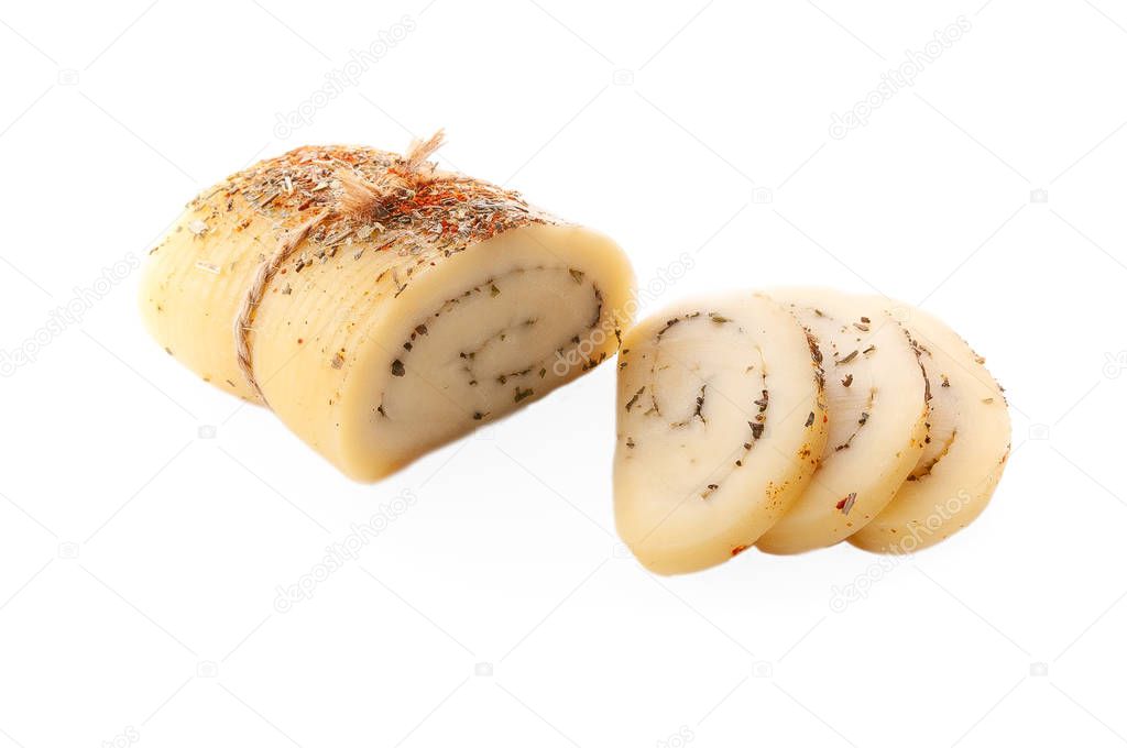 A set of cheeses. Halumi, Caciotta, Caciocavallo, cheese sticks, Suluguni, Belper knolle, cheese roll with Provencal herbs.On a wooden board and gray linen cloth. View from above.