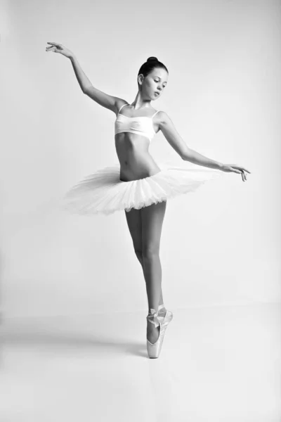 Young girl dancing in ballet tutu and pointe shoes. Black and white photo.