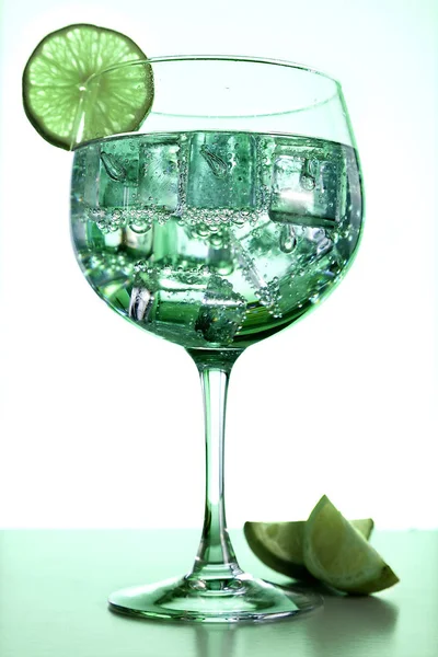 Gin tonic and lime on green — Stock Photo, Image