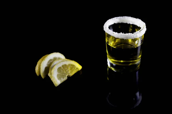 Tequila shot with lemon on black — Stock Photo, Image