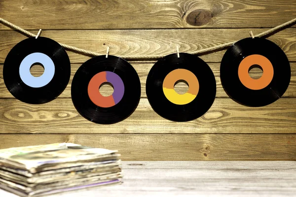 Quatro singles de vinil na mesa de madeira — Fotografia de Stock