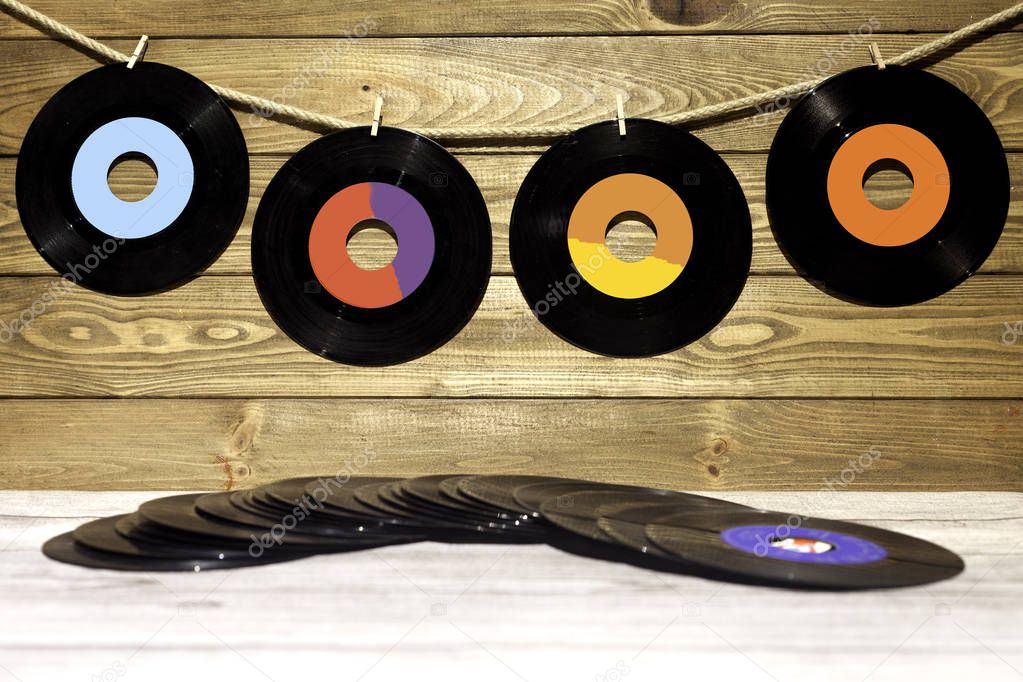 four vinyl singles on wood