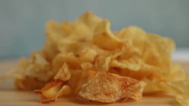 Patates cipsi açık mavi arka planda dönüyor. Boşluğu kopyala