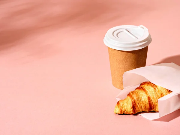 Cup of coffee and croissant.