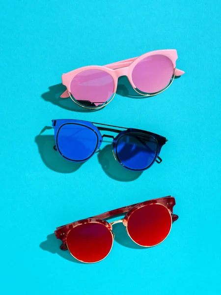 Summer background with three colourful sunglasses. — Stock Photo, Image