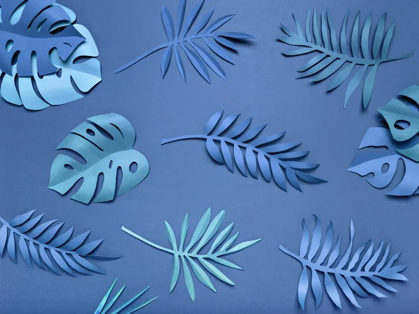 Bright blue tropical paper leaves. — Stock Photo, Image
