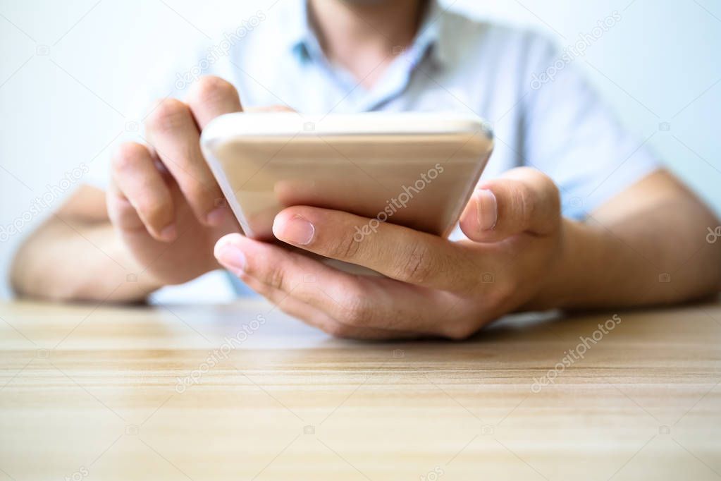 Man playing smartphone on the table