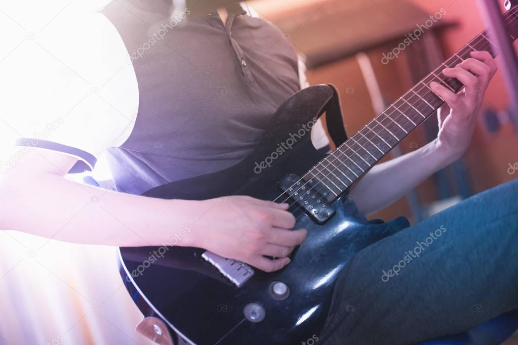 Close up of a man playing electric guitar