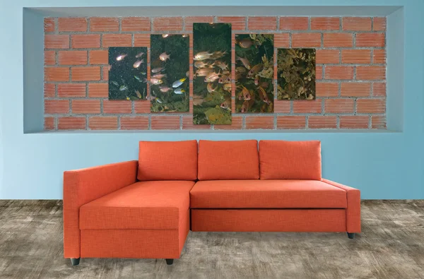 orange sofa furniture and underwater photo collage on brick wall