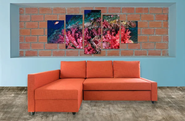 orange sofa furniture and underwater photo collage on brick wall