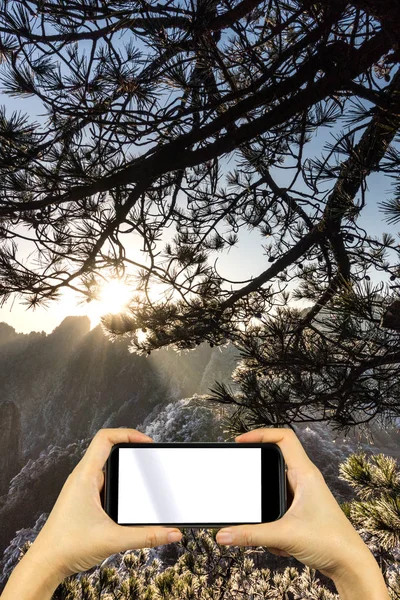 shoot photo with smartphone. Mountain Huangshan scenery.