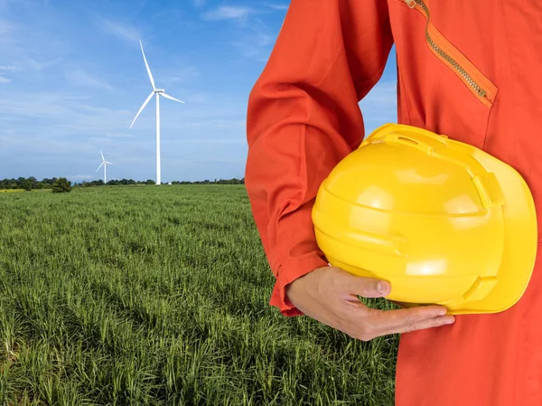 safety suit and hand hold yellow helmet with Wind turbines gener