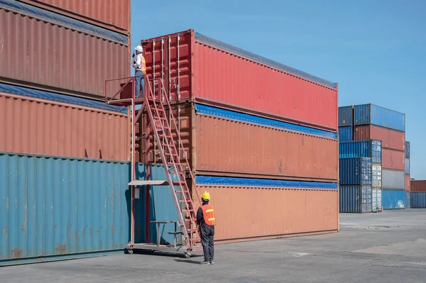 Foreman control loading containers box from cargo freight ship for import export, Foreman control industrial container cargo freight ship, Business import and export logistic concept.