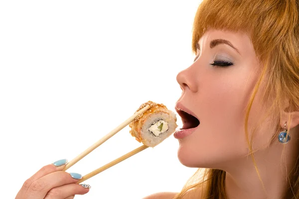 Attractive girl with pleasure eating roll — Stock Photo, Image