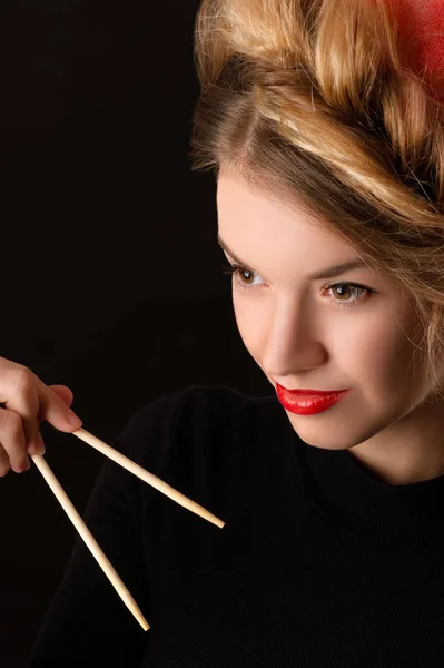 Beautiful young woman with chopsticks — Stock Photo, Image