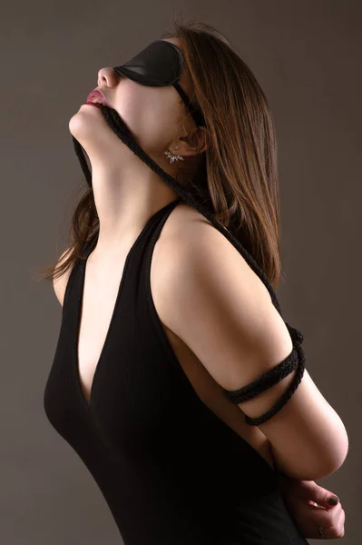 Attractive brunette girl with blindfold on eyes — Stock Photo, Image