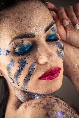 esmer kadın yüzü parlak makyaj ile rhinestones closeup ile 