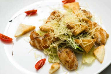 chicken salad with vegetables on white plate