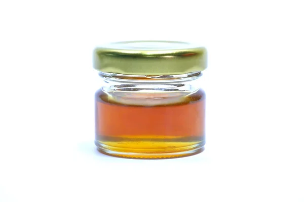 Miel dans une bouteille en verre Fond blanc — Photo