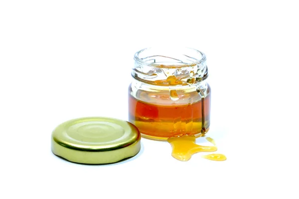 Honey in a glass bottle White background — Stock Photo, Image