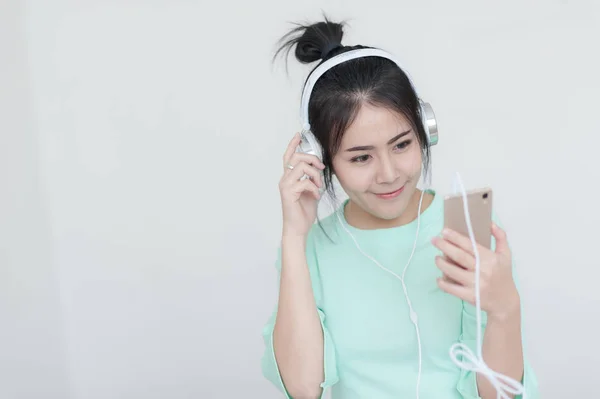Genç Asyalı kadın smartphone ile müzik dinleme