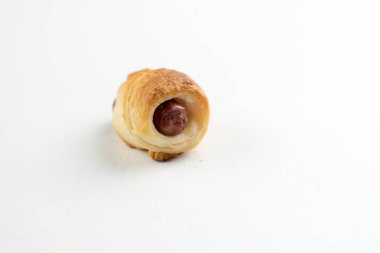 Ev domuzlar bir battaniyeye yaptı. Sosis pişmiş ve beyaz zemin üzerine yerleştirilmiş kruvasan hamur yuvarlandı.