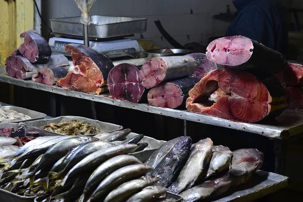 Raw fishes on fish market stall on street. Fresh seafood market vendor. Nuwara Eliya, Sri Lanka.